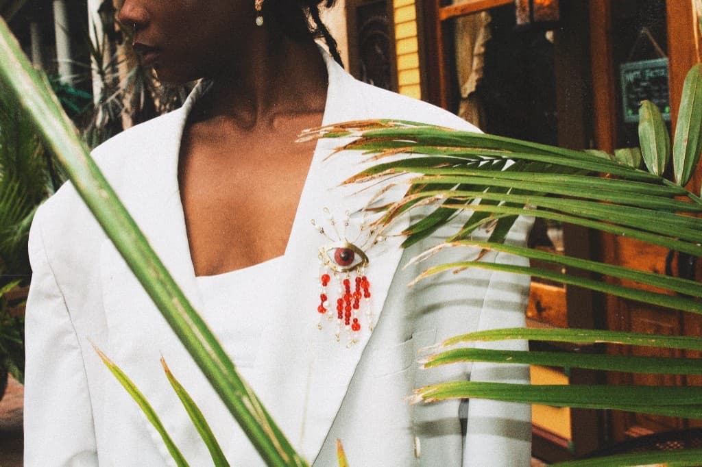 Blood & Tears brooch campaign shot through palm fronds in West Palm Beach